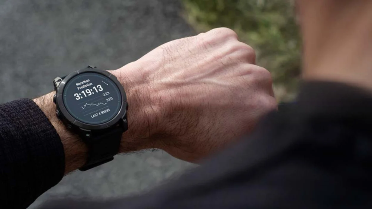 man looking at Garmin Epix Pro smartwatch on wrist