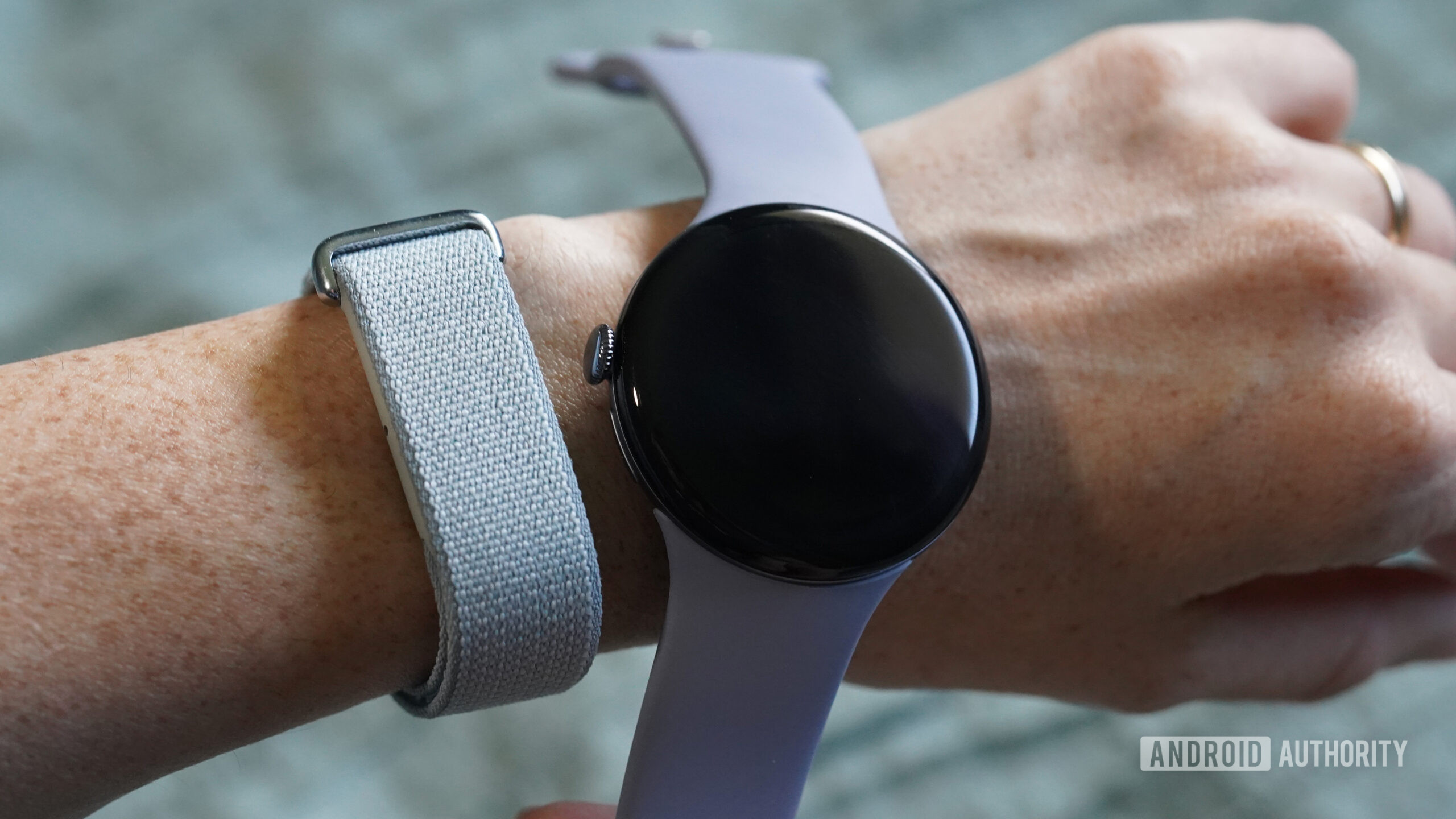 Google Fitbit Air Pixel Watch 4 A user wears a Google Fitbit Air and holds a Pixel Watch 4 alongside it.