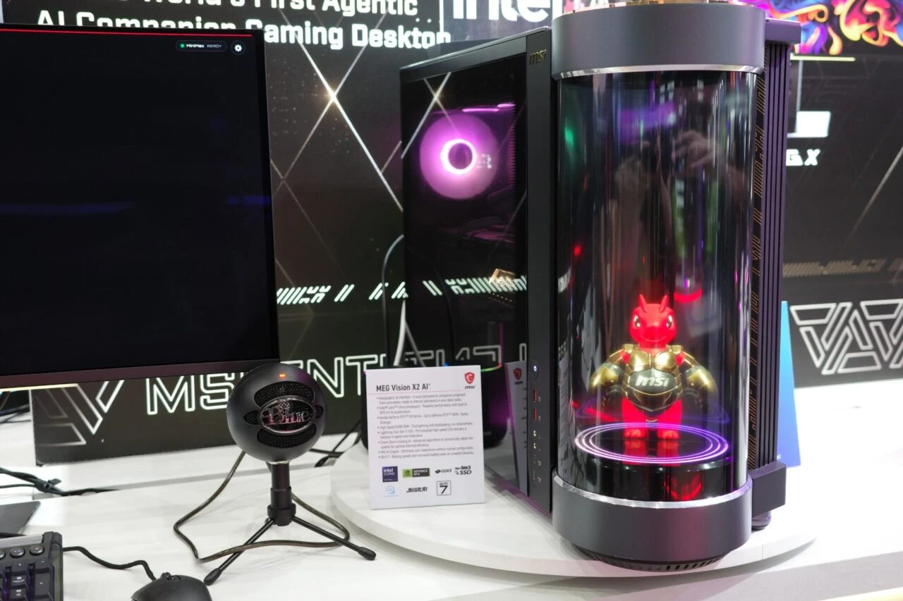 Msi Meg X2 Vision Desktop next to a monitor and a microphone