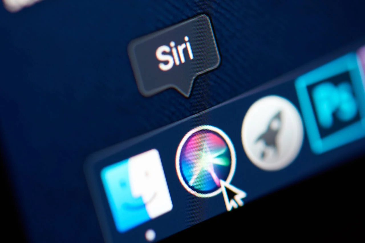Someone clicking Siri in the dock on a Mac desktop