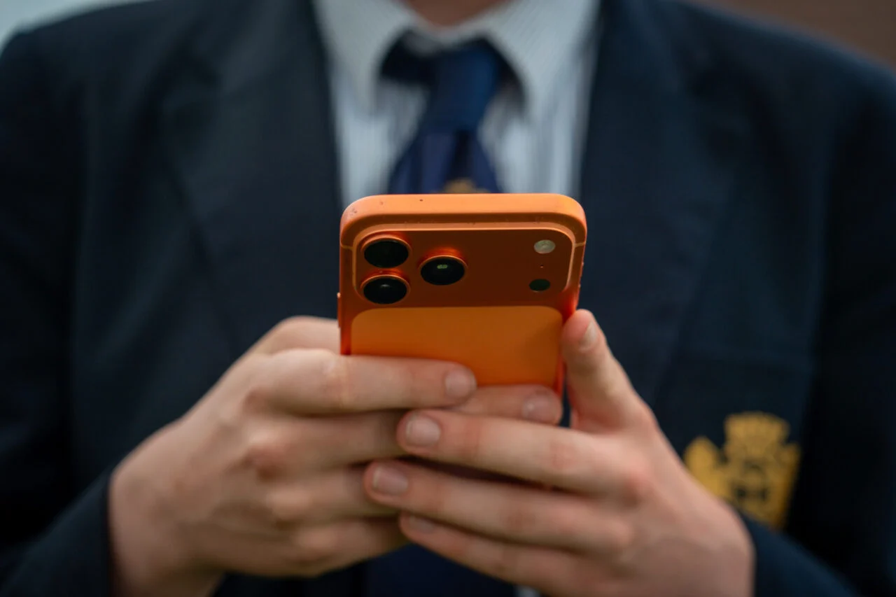 A teenager using an iPhone