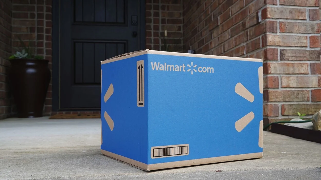 a walmart.com delivery box sits on a doorstep of a home