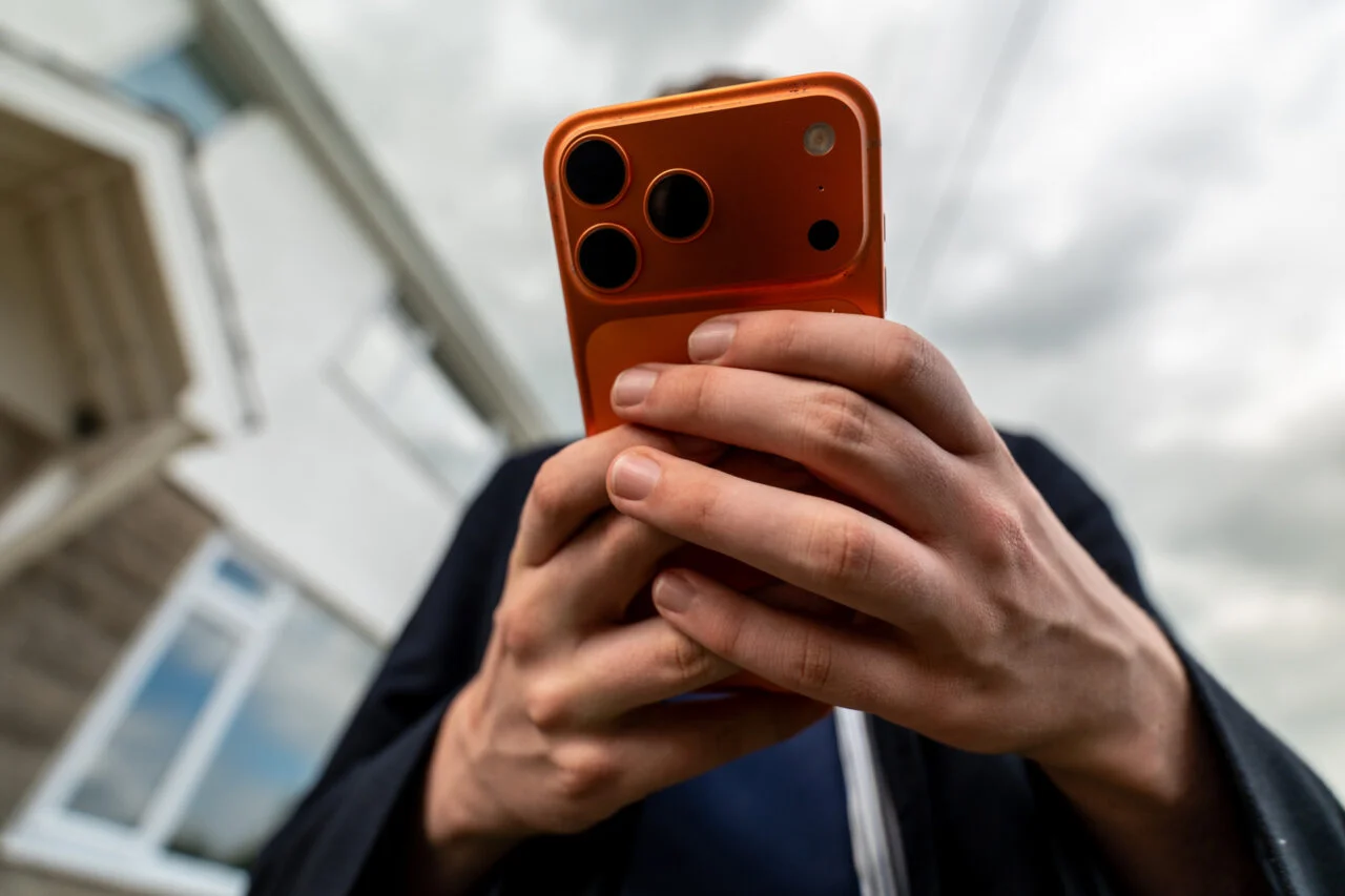 A young person holding an iPhone