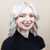 woman with short blonde hair smilling