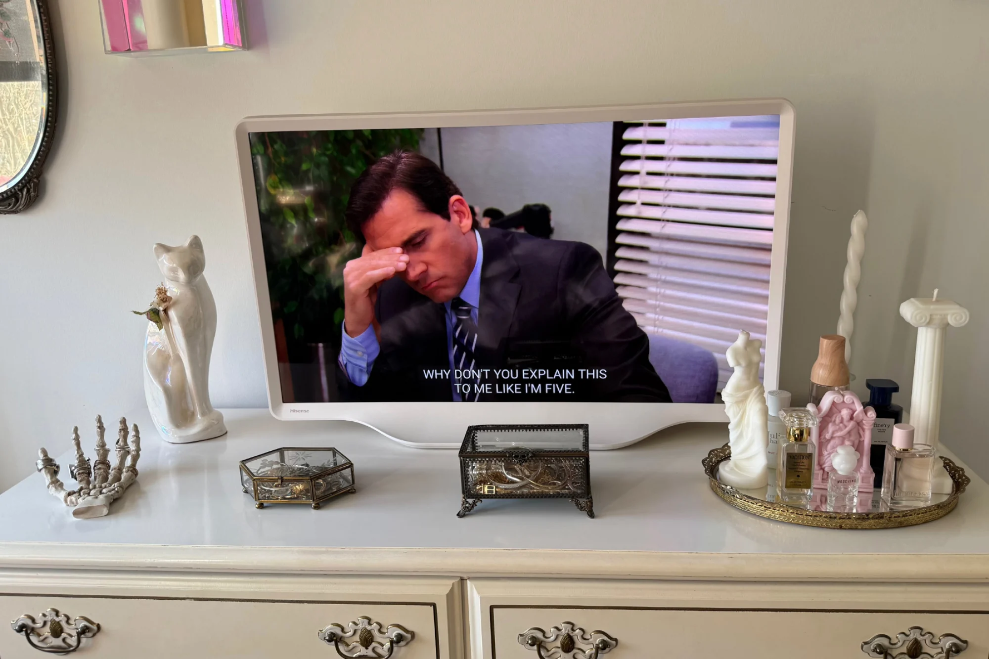 Hisense D&eacute;co TV sitting on dresser while playing a scene from "The Office"