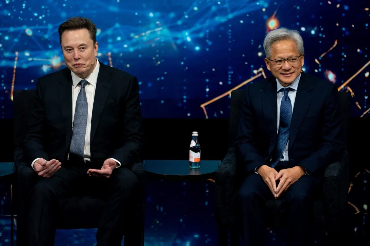 Elon Musk, chief executive officer of Tesla Inc., left, and Jensen Huang, chief executive officer of Nvidia Corp., during the US-Saudi Investment Forum at the Kennedy Center in Washington, DC, US, on Wednesday, Nov. 19, 2025.