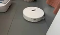 Roborock Qrevo Curv 2 Flow robot vacuum mopping tile floor near shower