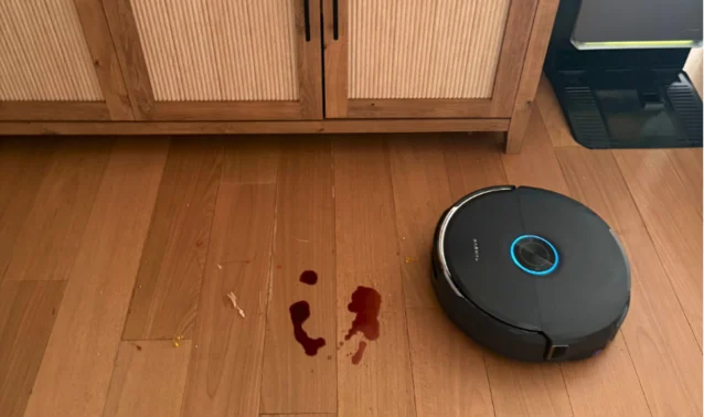 Narwal Flow 2 robot vacuum mopping wine spill on hardwood floor