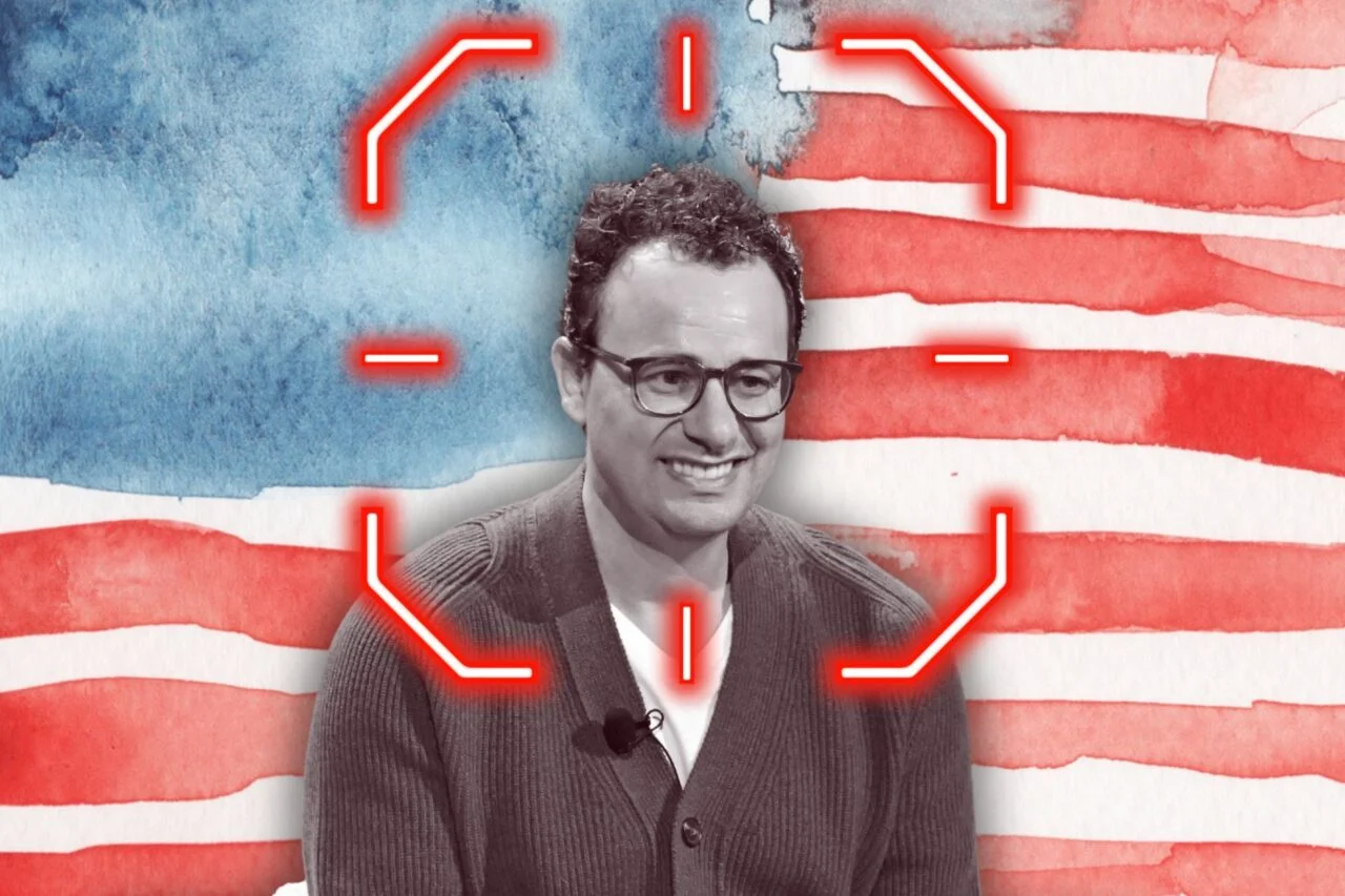 Dario Amodei is seen with a crosshairs on his head and an American flag in the background.
