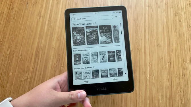 A person holding the Kindle Paperwhite Signature Edition