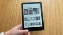 A person holding the Kindle Paperwhite Signature Edition
