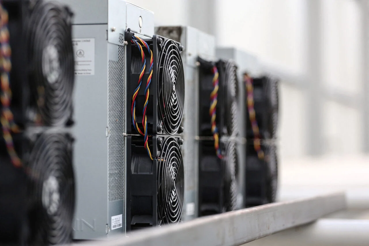 Photo of four bitcoin mining rigs in a row.