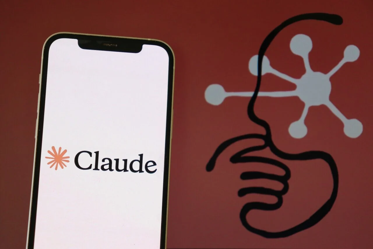The Claude logo is displayed on a smartphone screen.