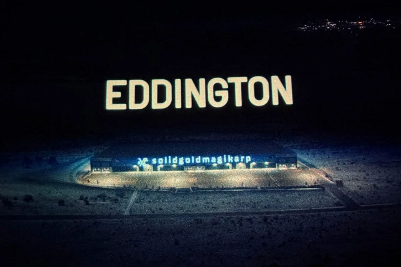 Screenshot from Eddington showing a large building with a sign that reads "Solidgoldmagikarp."