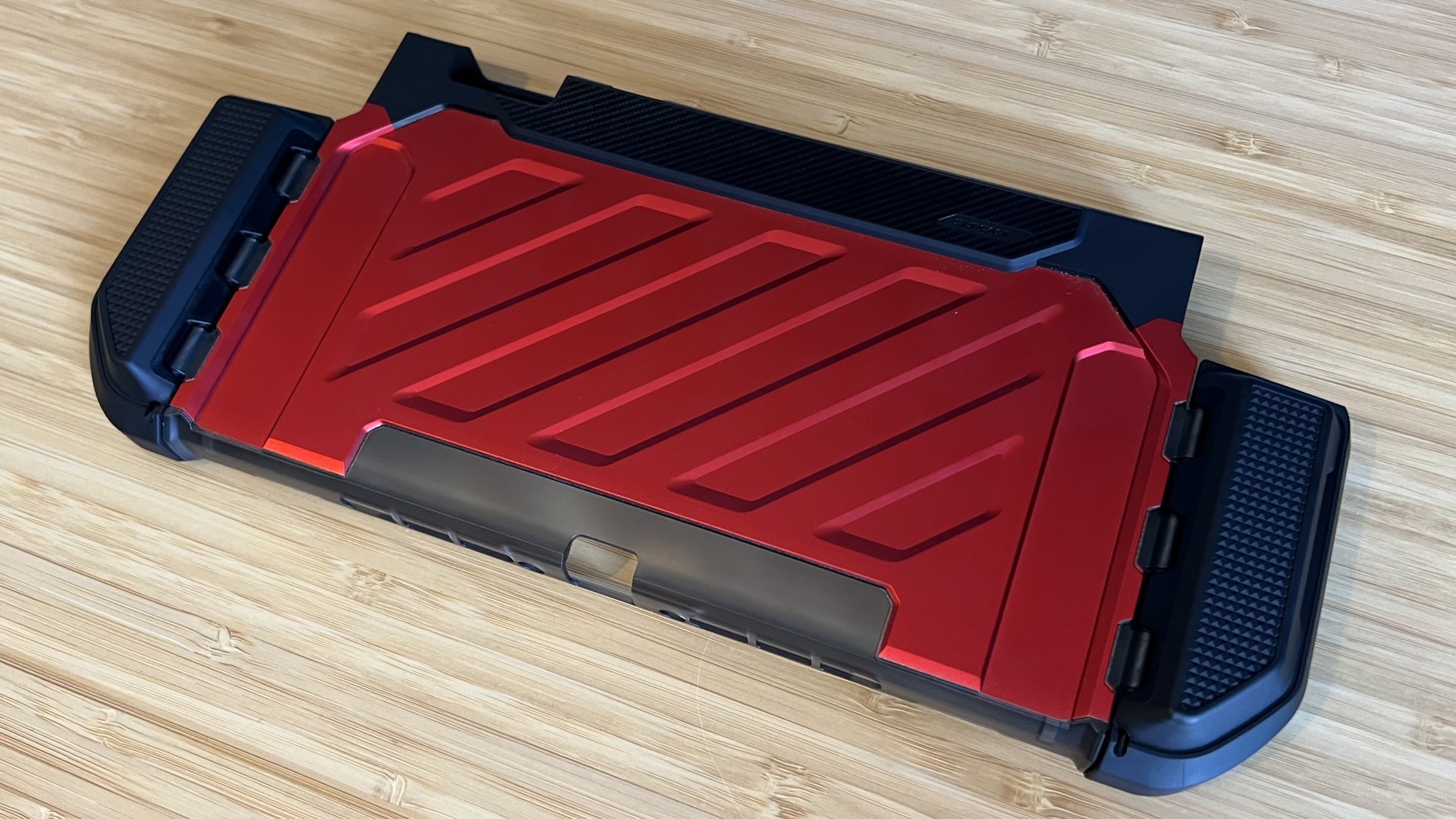 SupCase Unicorn Beetle Pro Nintendo Switch 2 case in red laying flat on a wooden desk