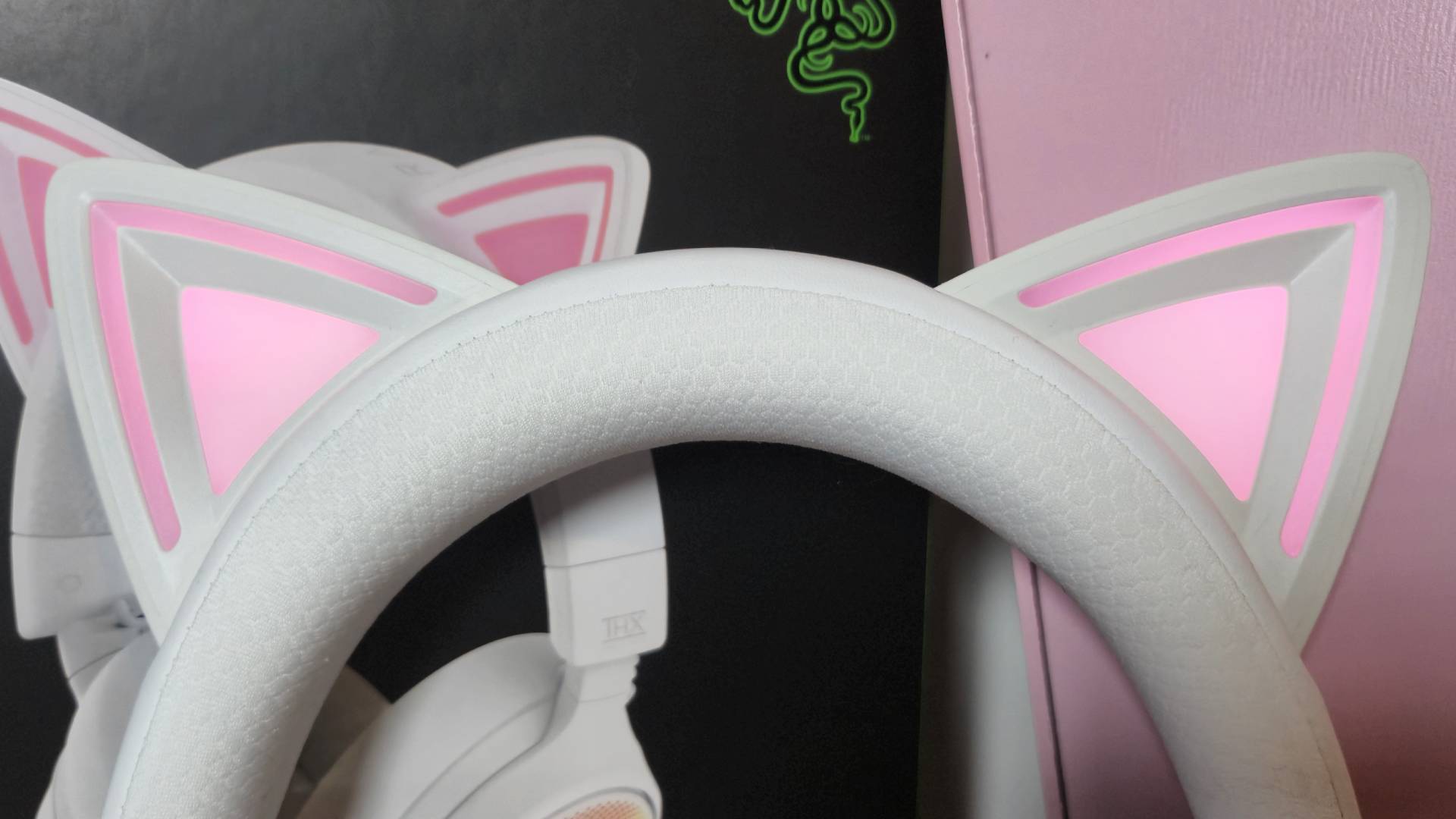 Close up photo of the Chroma-powered cat ears of the Kraken Kitty V3 Pro lit up pink.