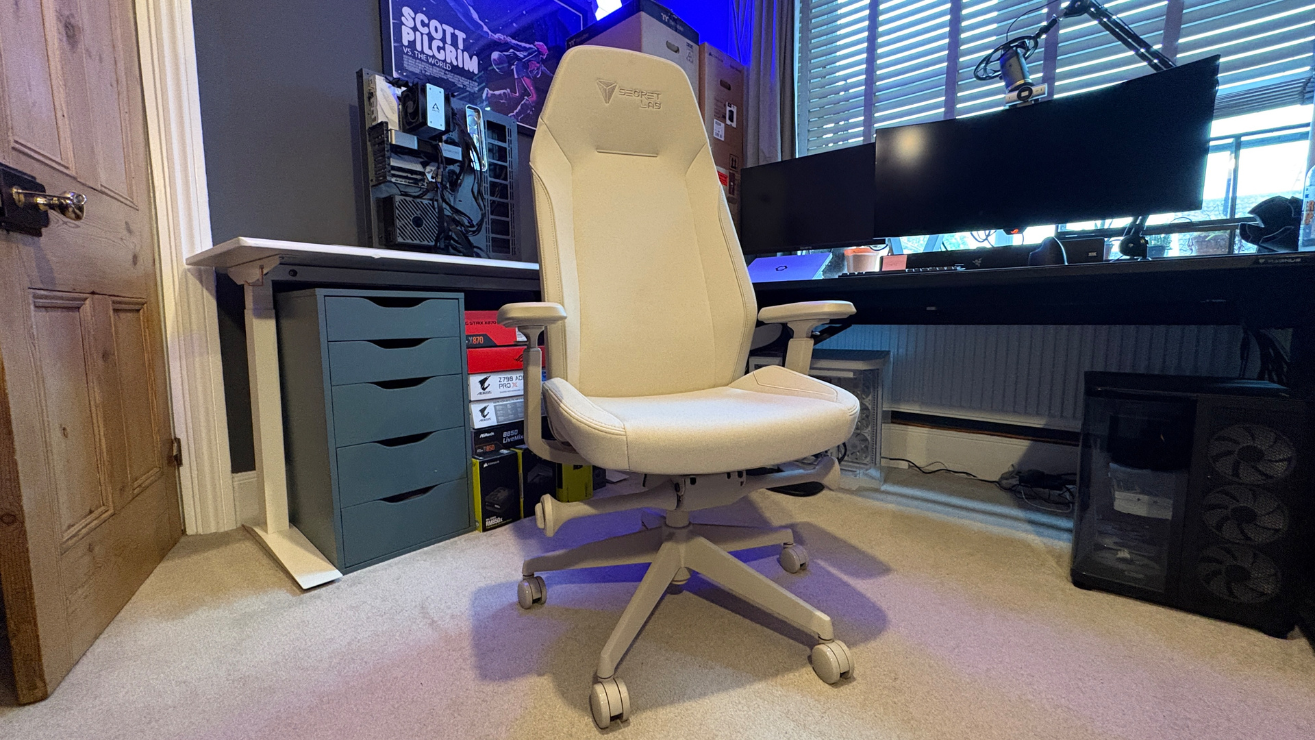 A Secretlab Atlas gaming chair in a home office during set-up and after it's completed.