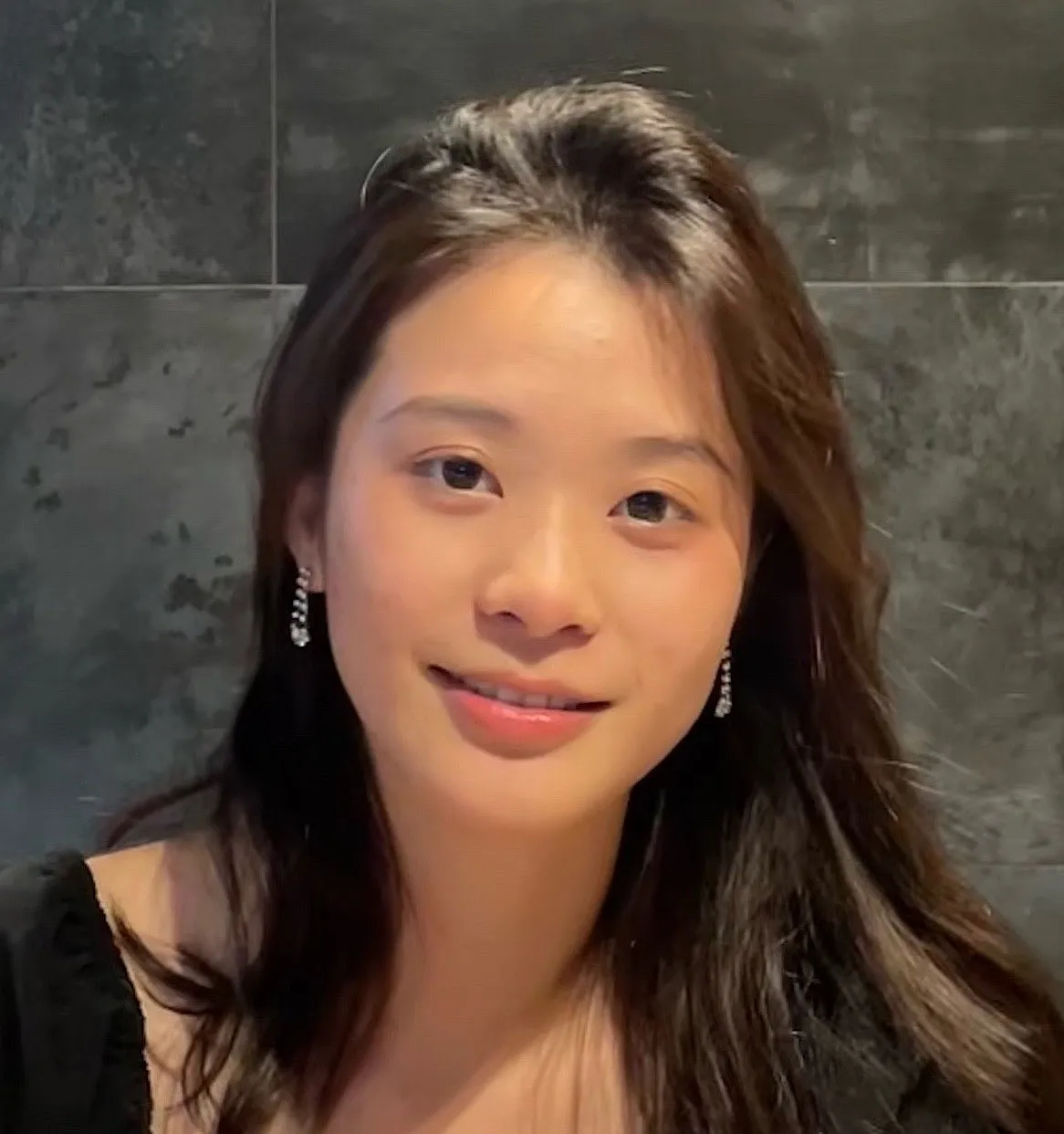 Photo of a woman with long dark hair smiling. 